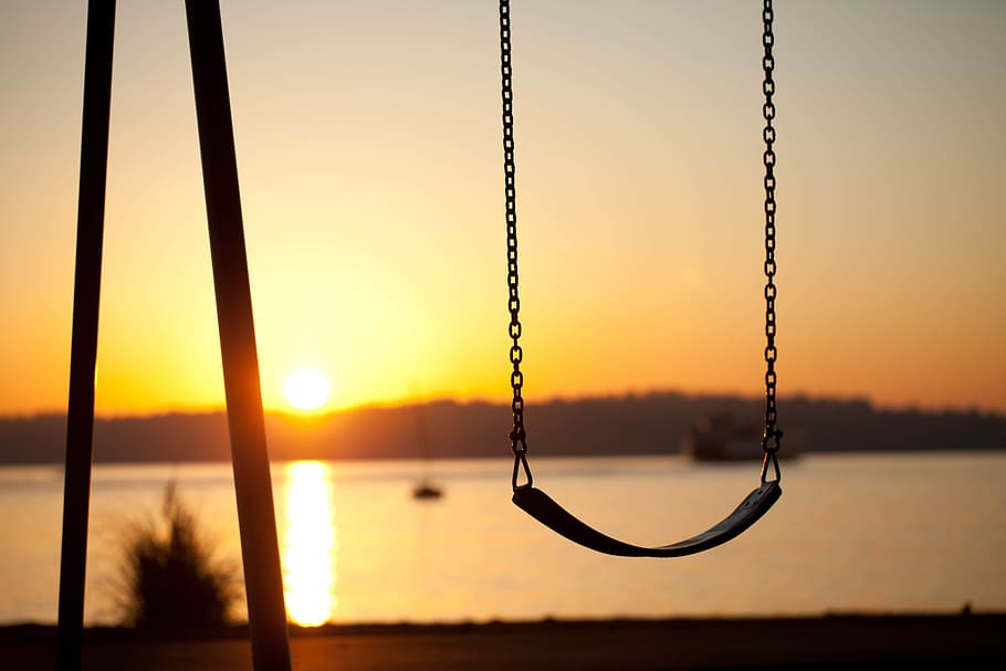 black swing facing sunlight, sunset, sky, silhouette, beauty in nature HD wallpaper