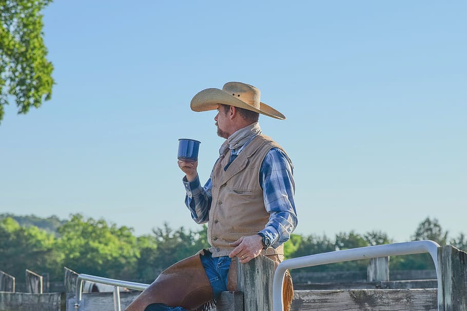 man standing while holding blue cup, hat, real people, one person HD wallpaper