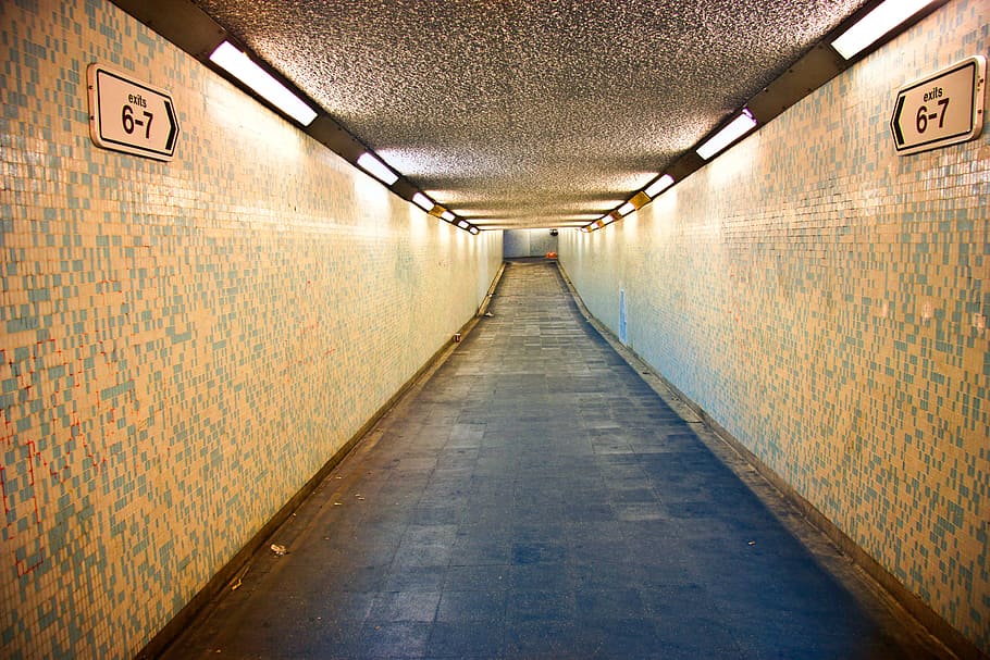 Illuminated Empty Underground Walkway In London, the way forward