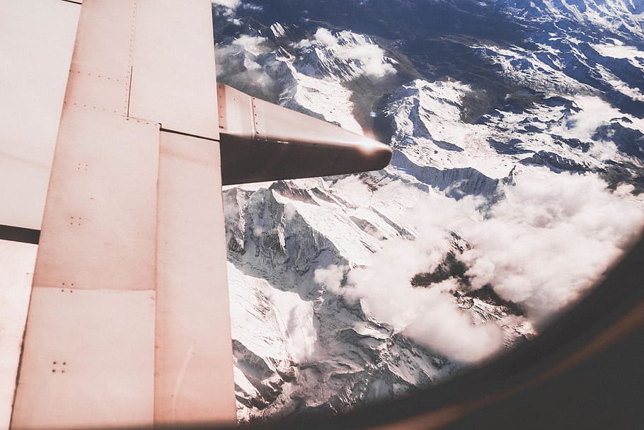 snow capped mountain range viewed from plane window, nature, outdoors