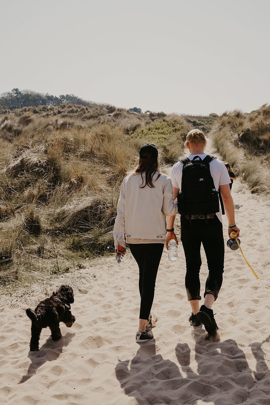 woman wearing white sweater besides man carrying black backpack, HD wallpaper