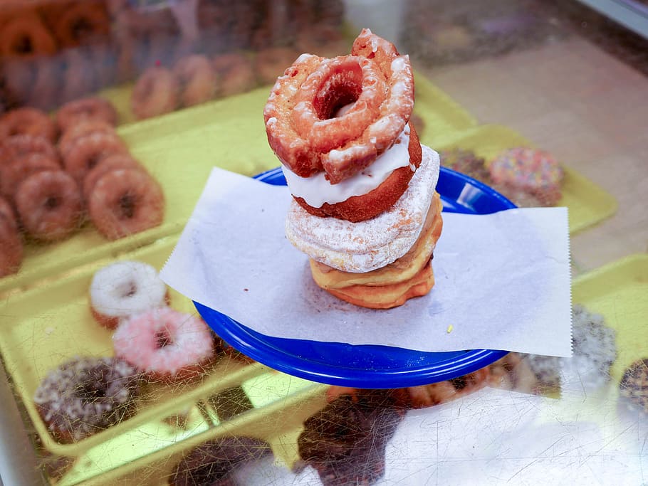 A bunch of donuts stacked on a blue plate., bakery, breakfast HD wallpaper