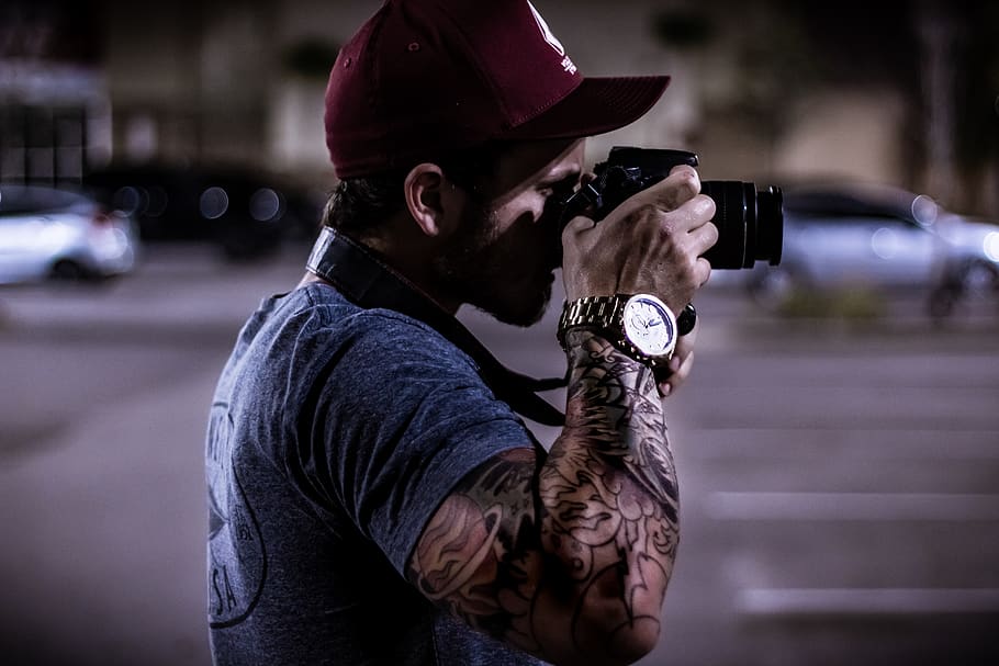 Man in Gray Tee Shirt Using Camera Standing Near Road, action HD wallpaper