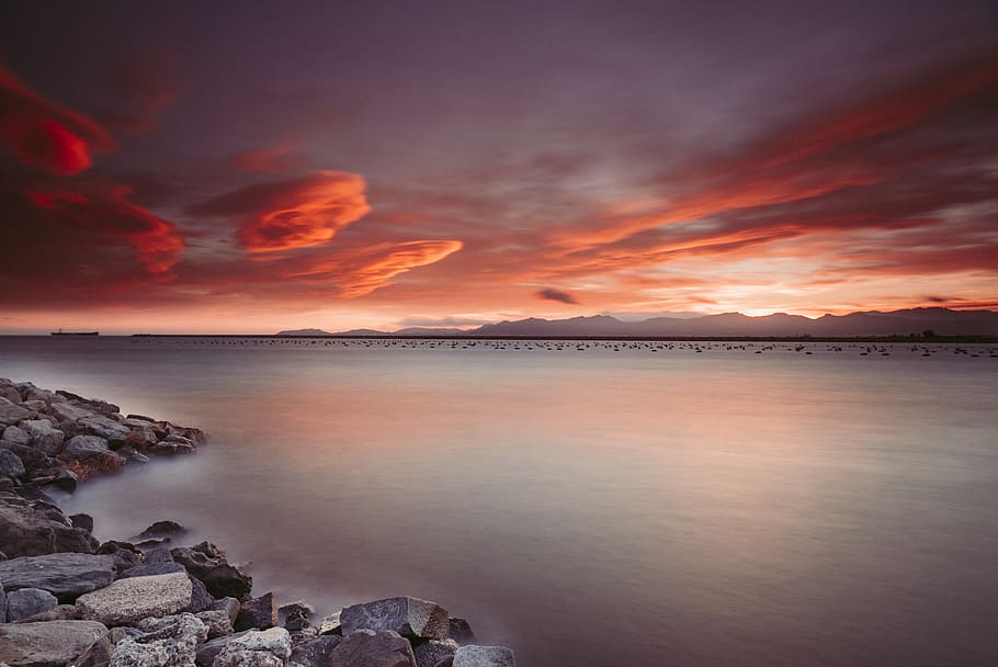 Landscape Photography of Rocks Near Body of Water during Sunset HD wallpaper