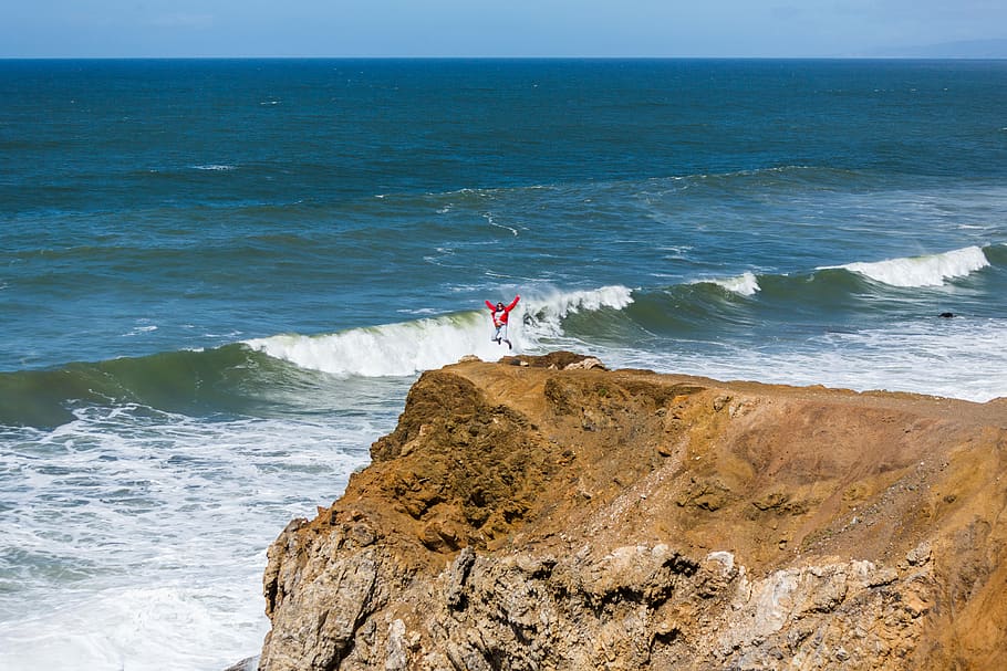 jumping, ocean view, cliff, sea, water, land, beach, horizon HD wallpaper
