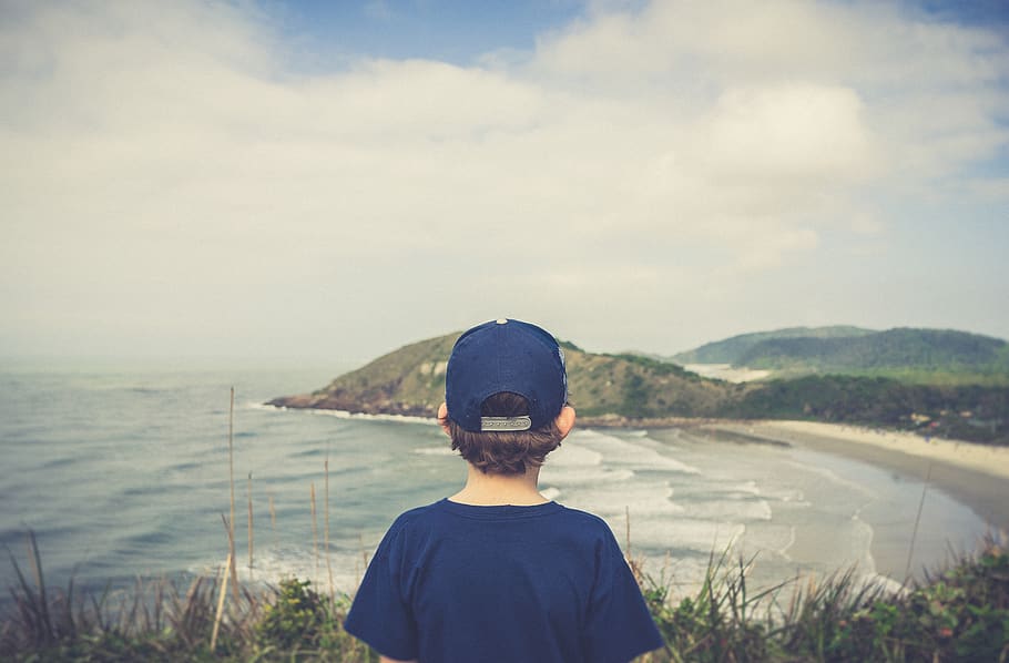Boy Standing Near Cliff, beach, day, daylight, fun, landscape HD wallpaper