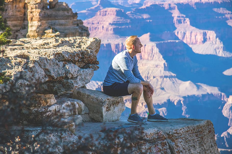 man sitting on cliff mountain, outdoors, nature, person, human HD wallpaper