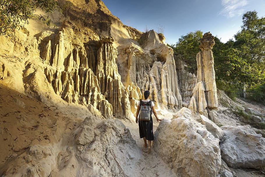 Woman Standing Near Rock Formation, backpack, blue sky, cliff HD wallpaper