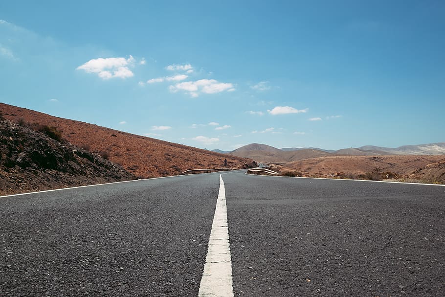 empty road between brown grasses, direction, road marking, symbol HD wallpaper