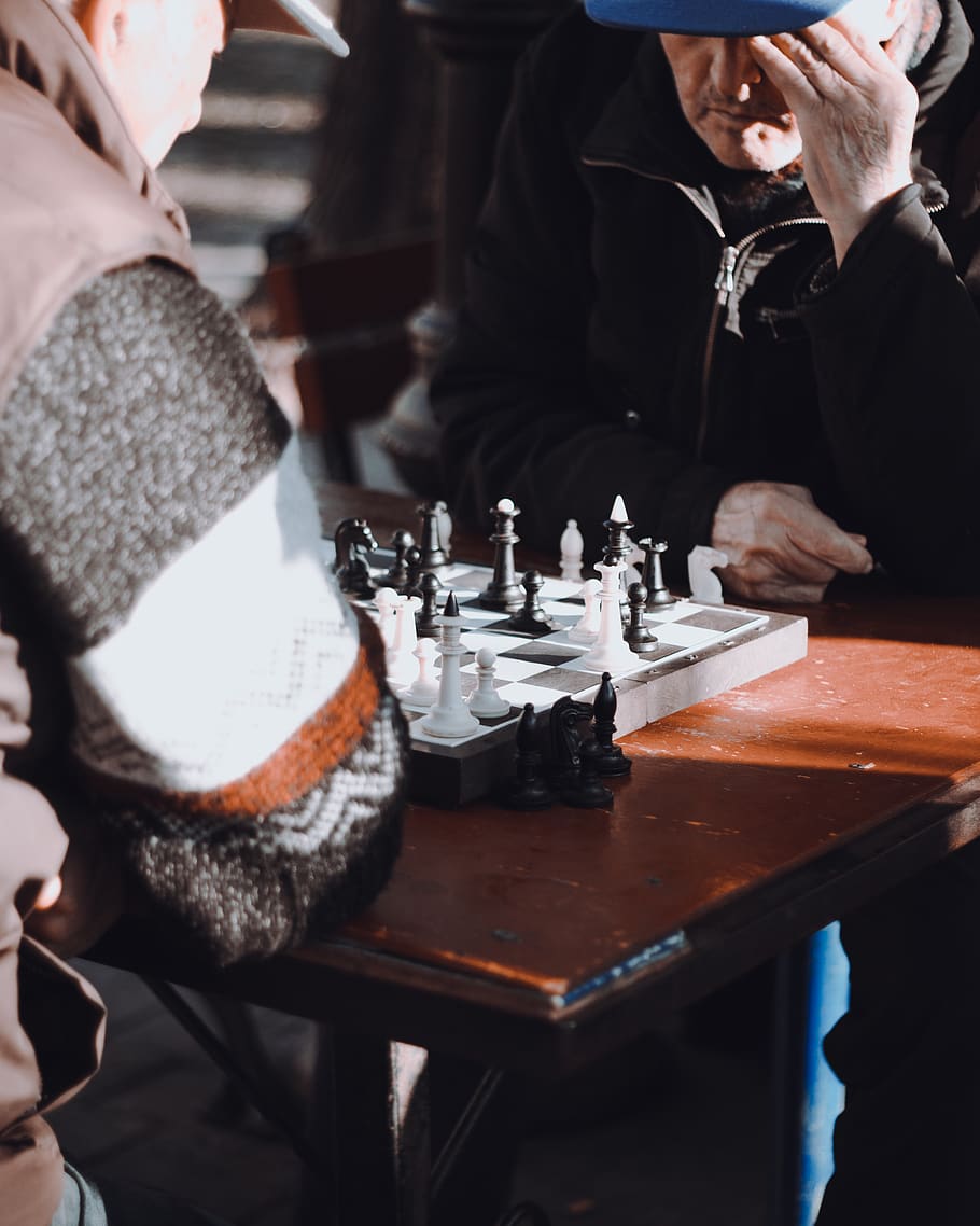 two men playing chess, real people, table, human hand, one person HD wallpaper