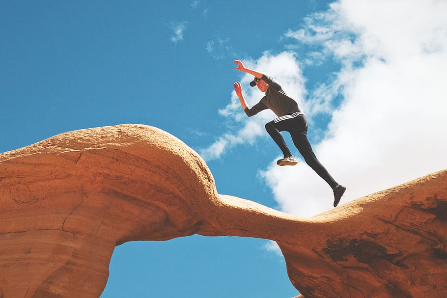 man jumping on rock formation, human, person, nature, outdoors HD wallpaper