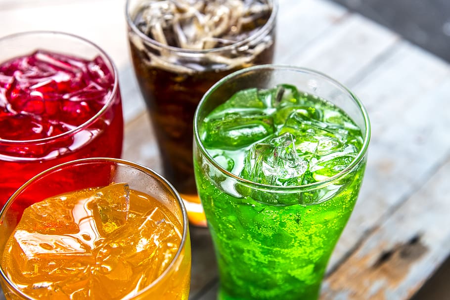 Four Assorted-flavored Drinks in Clear Drinking Glasses, beverages