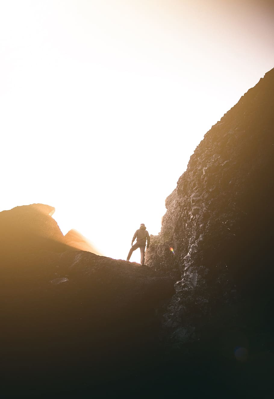 silhouette photography of man standing on mountain, person, sun
