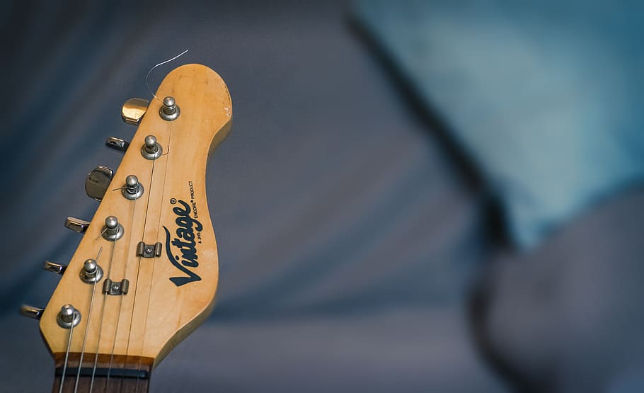 selective focus photography of guitar headstock, musical instrument