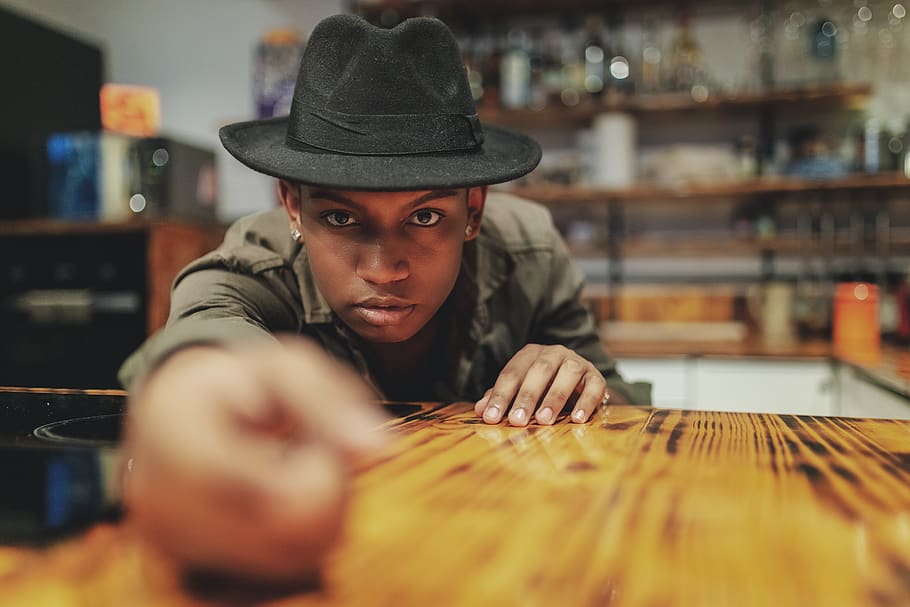 Man Leaning on Wooden Table, focus, hands, hat, indoors, model HD wallpaper