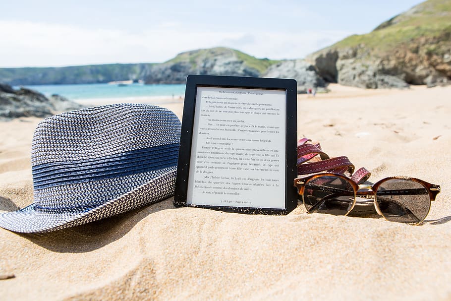Shallowfocus Photography of Fedora Hat, Photo Frame, and Sunglasses on Beach HD wallpaper