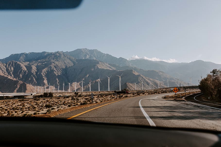 windmills in field ahead, mountain, transportation, road, sky HD wallpaper