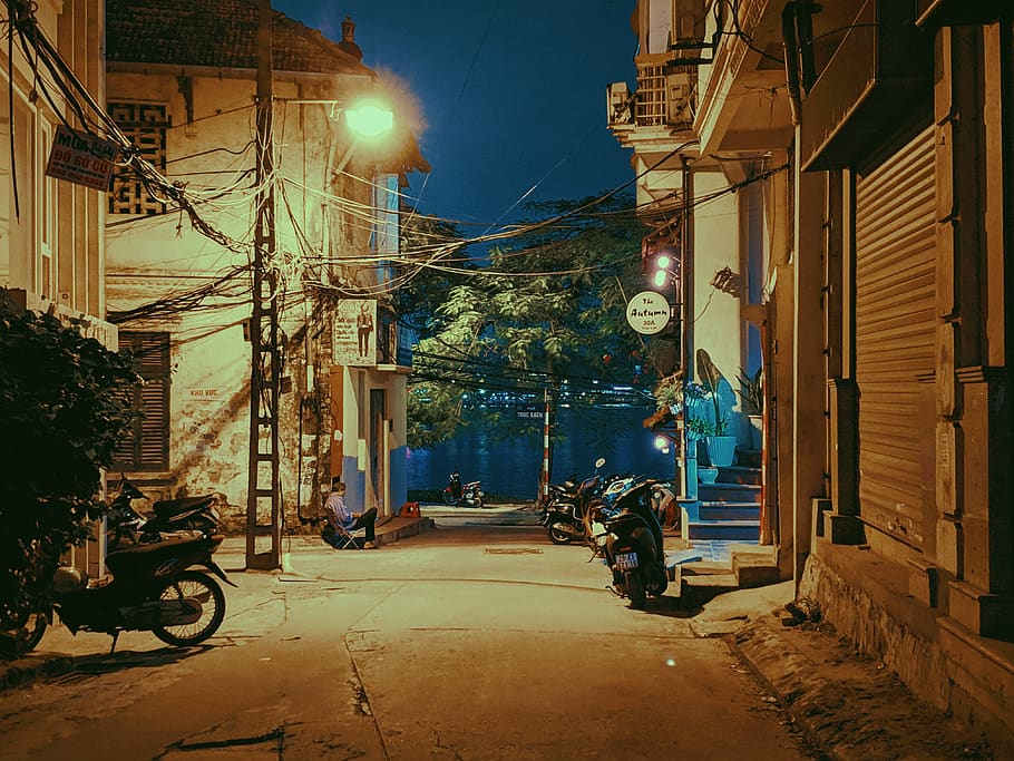 Motorcycles Parked Beside Buildings at Night, architecture, cable wires HD wallpaper