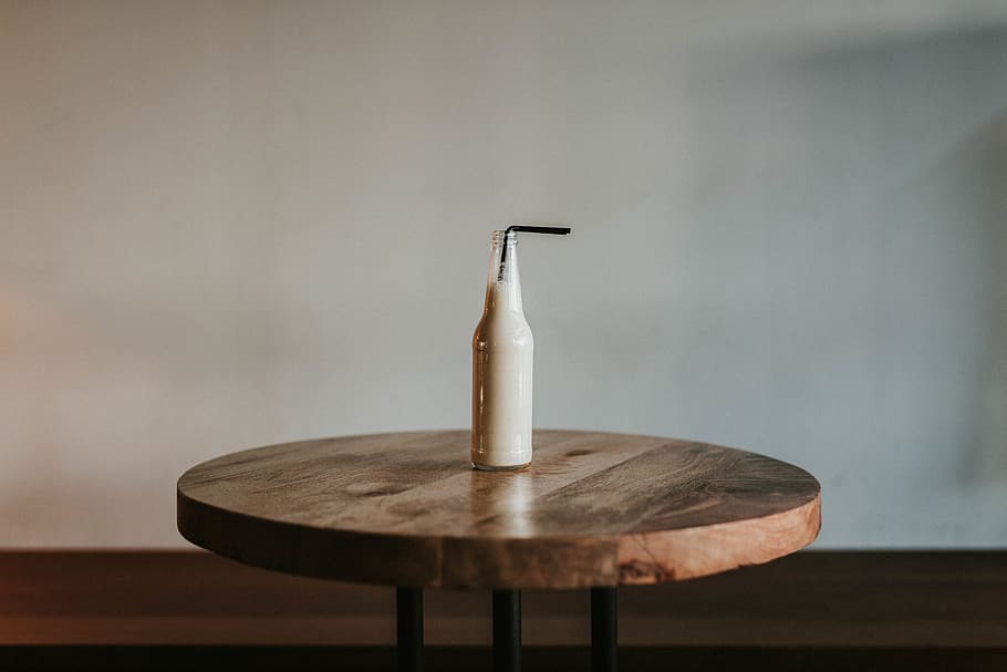 Glass Bottle Filled With Black Straw on Brown Wooden Table, drink HD wallpaper