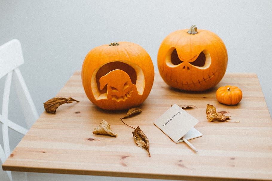 two orange pumpkins on brown wooden table, carving, halloween HD wallpaper