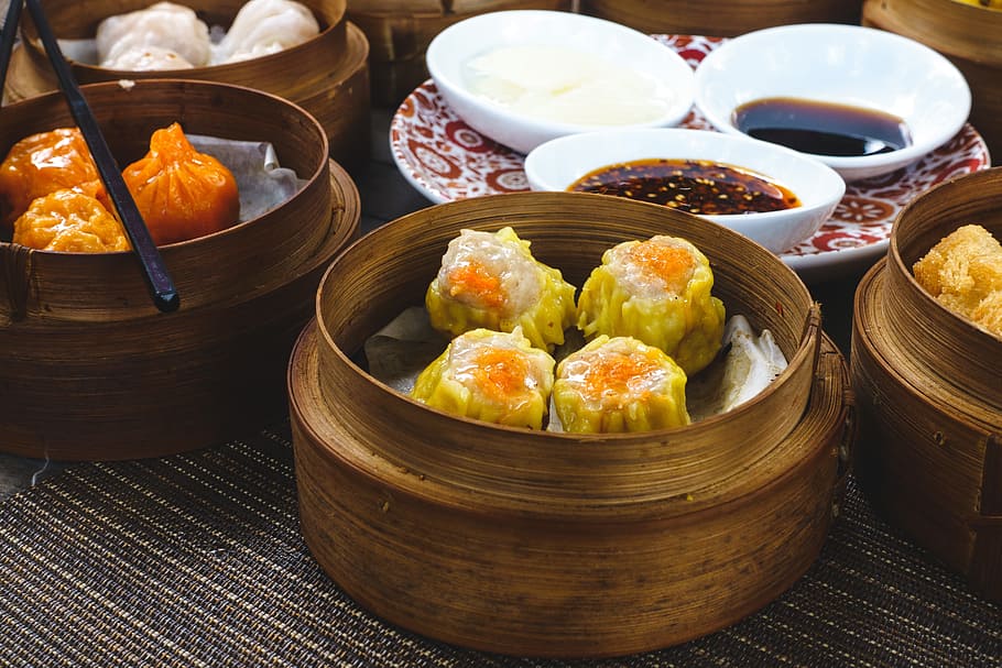 Chinese steamed and fried dim sum in wooden steamers, asian, close up