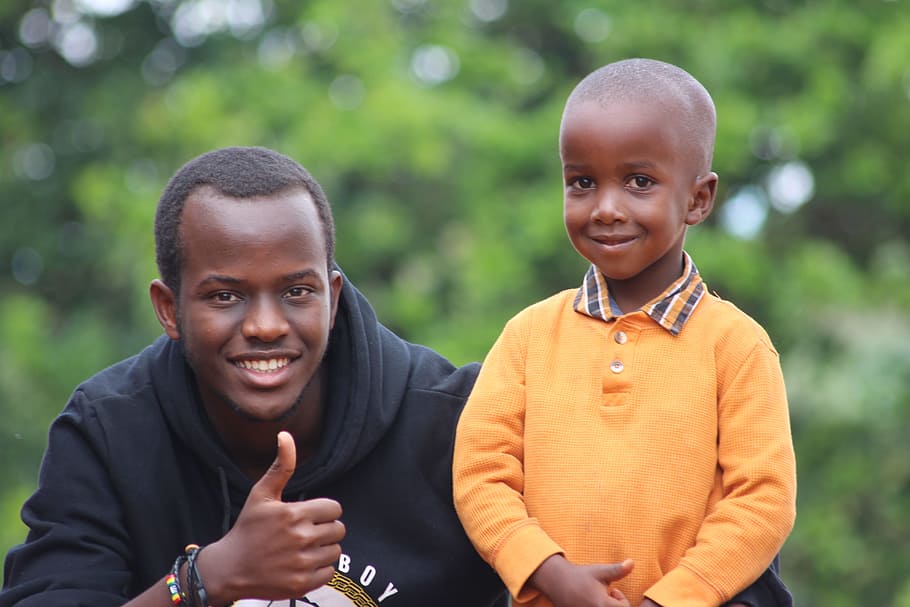 Man Wearing Black Hoodie Beside Boy Wearing Orange Long-sleeved Polo Shirt HD wallpaper