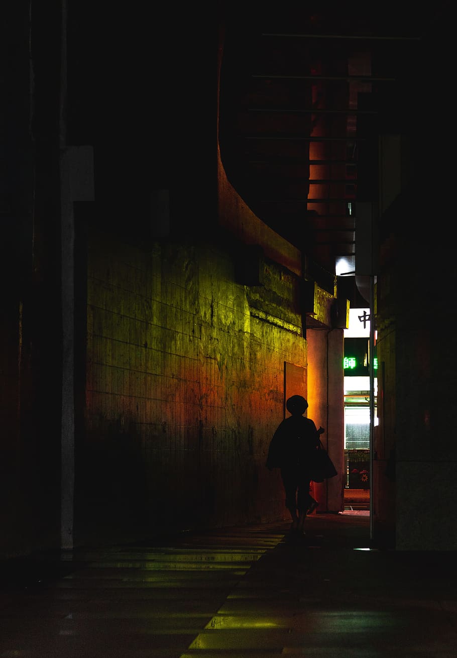 silhouette of person walks on hallway, building, neon, light