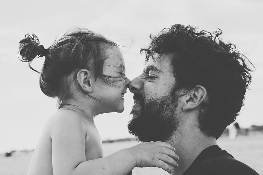 Father and daughter touch noses, smiling in black and white photo, HD wallpaper