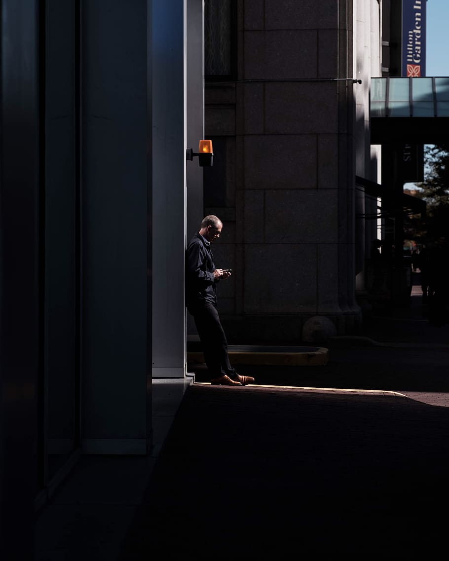 man standing near wall, person, human, building, city, urban HD wallpaper