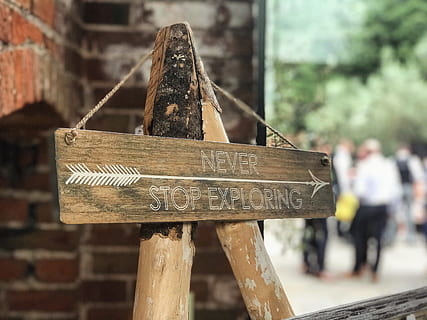 Never Stop Exploring Signboard, arrow, art, blur, blurred background HD wallpaper