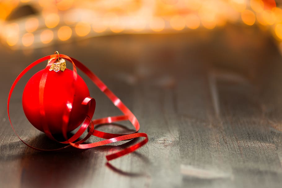 Red Christmas Bauble With Red Ribbon on Wooden Surface in Close Up Photography HD wallpaper
