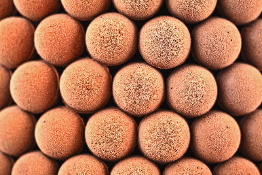 round brown balls, food, confectionery, sweets, brick, texture HD wallpaper
