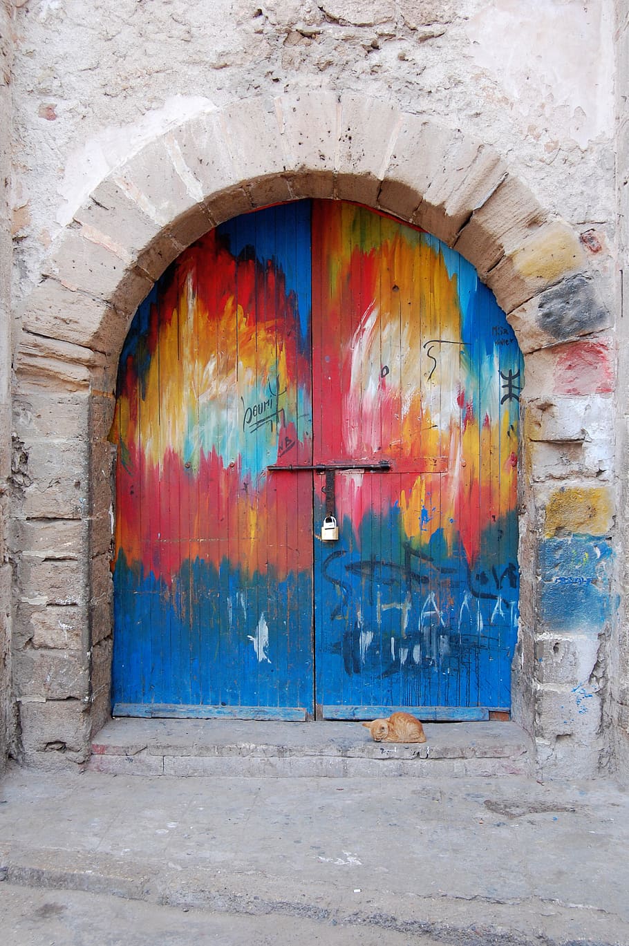 A colorfully painted rounded door., architecture, multi colored