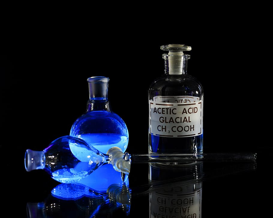 Chemical solutions glowing uner a black light., science, chemicals