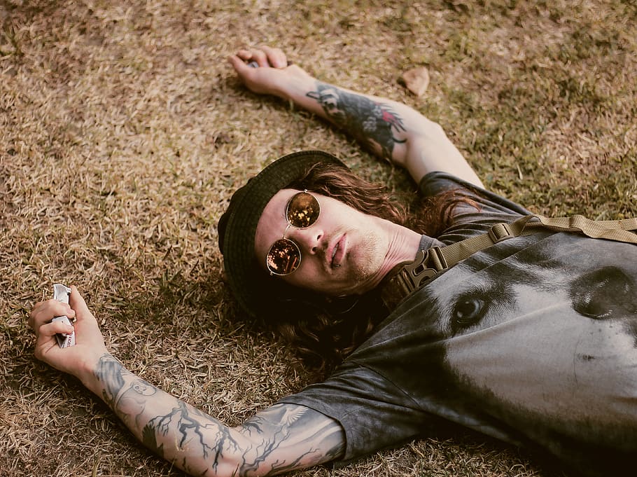 man lying on dried grass, lying down, one person, real people HD wallpaper