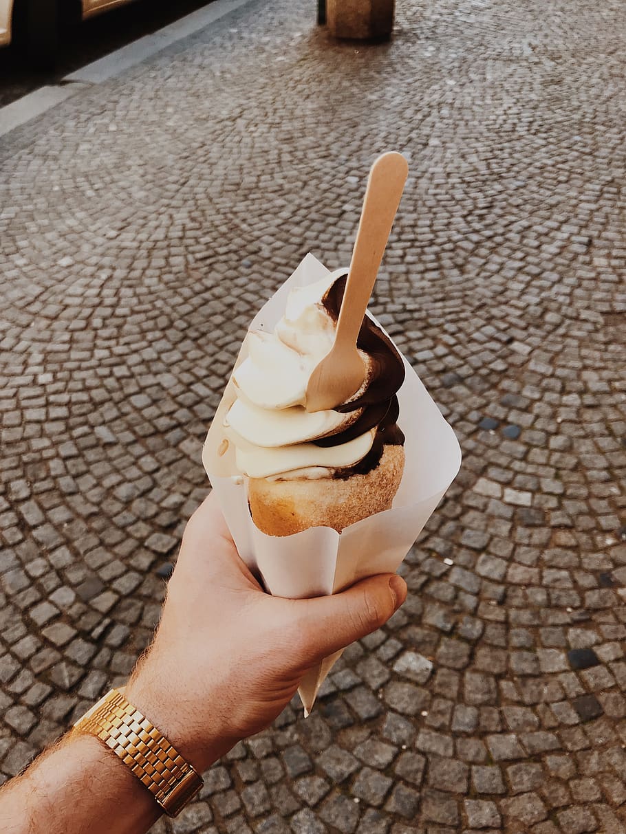 Person Holding Soft Serve Ice Cream, chocolate, close-up, cobblestone street, HD wallpaper