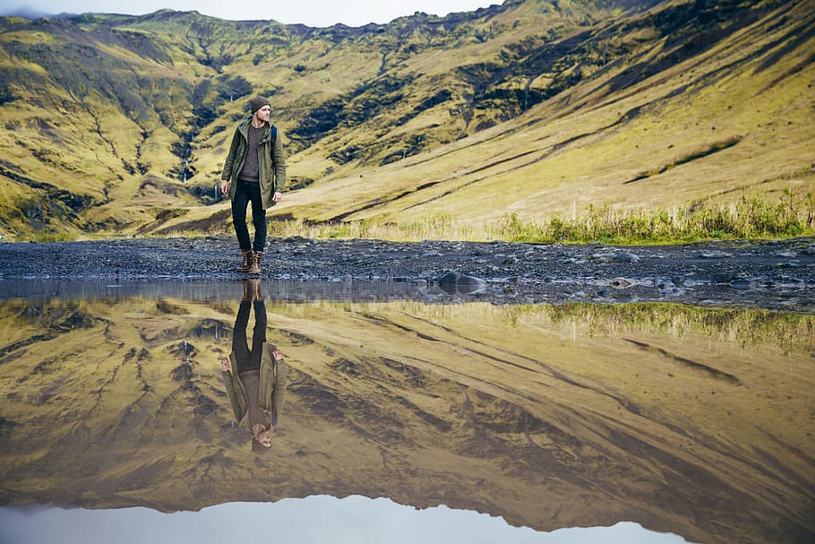 A young caucasian hiker s reflection in the lake, adventure, boot