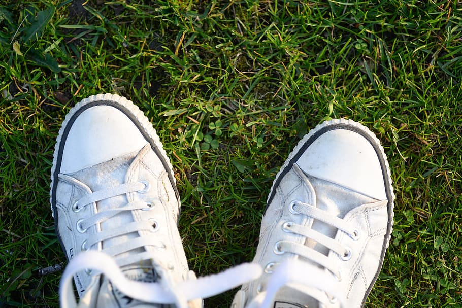 Pair of White Lace-up Sneakers on Top Green Grass, casual, classic