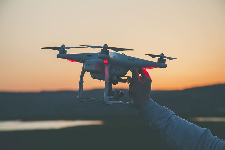 Photo of Person Holding Drone, blur, close-up, dawn, focus, hand, HD wallpaper
