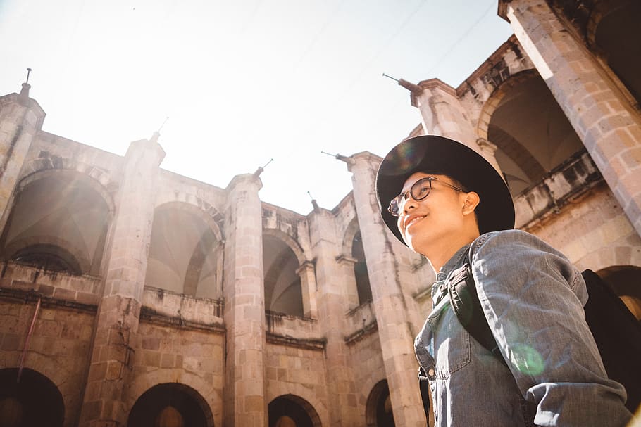 man smiling while looking at the building, architecture, hat HD wallpaper