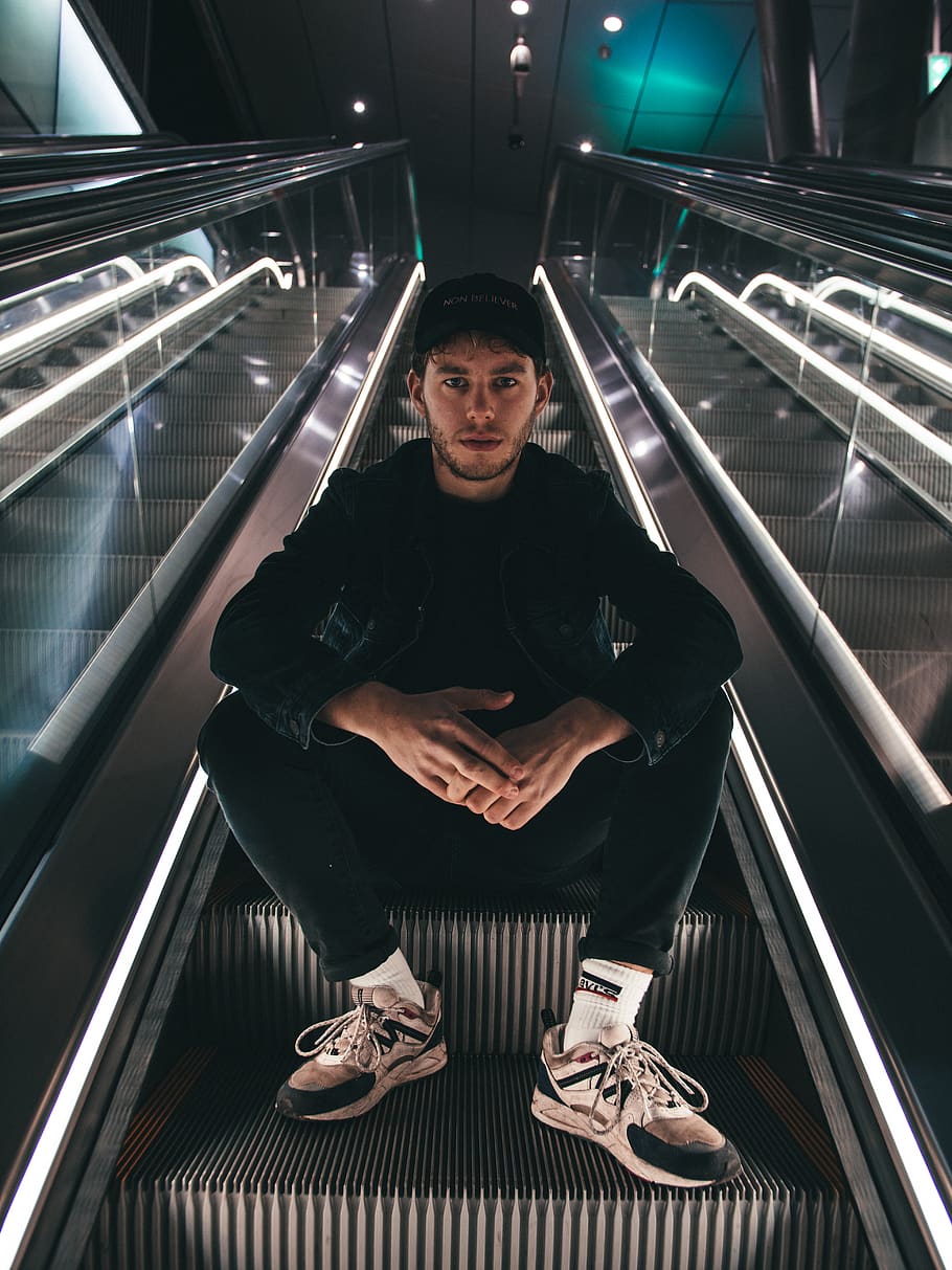 man sitting on escalator, one person, front view, real people HD wallpaper