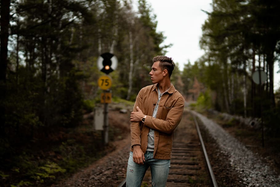 man facing sideways, person, outdoor, train track, rail, railway HD wallpaper