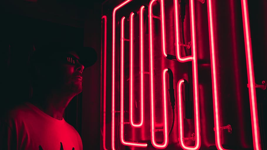 man stands beside red neon sign, light, human, person, apparel