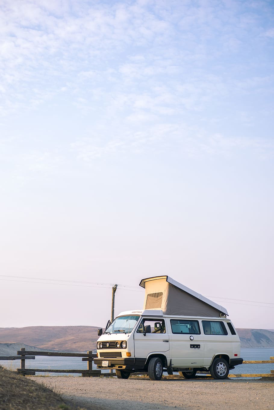 white van on brown soil at day time, sky, camper van, camping