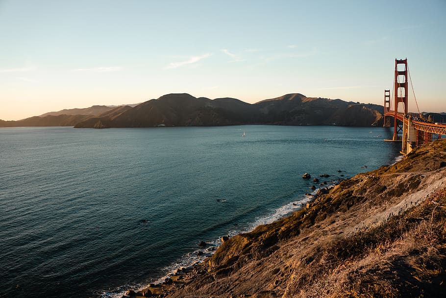 seashore photo during sunset, water, mountain, sky, beauty in nature HD wallpaper