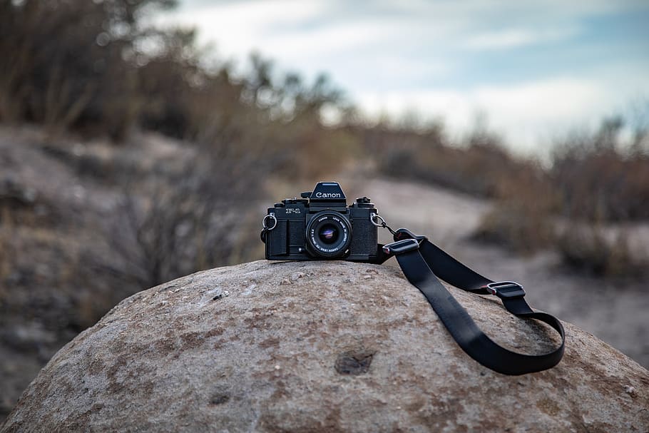 black DSLR camera on rock, strap, electronics, united states HD wallpaper