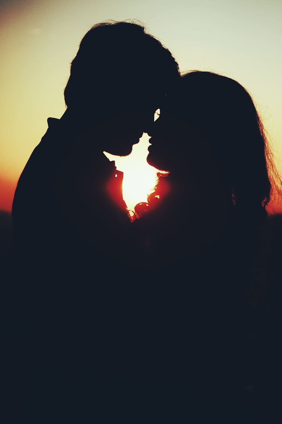 Silhouette Photo of Man and Woman About to Kiss, backlit, dawn