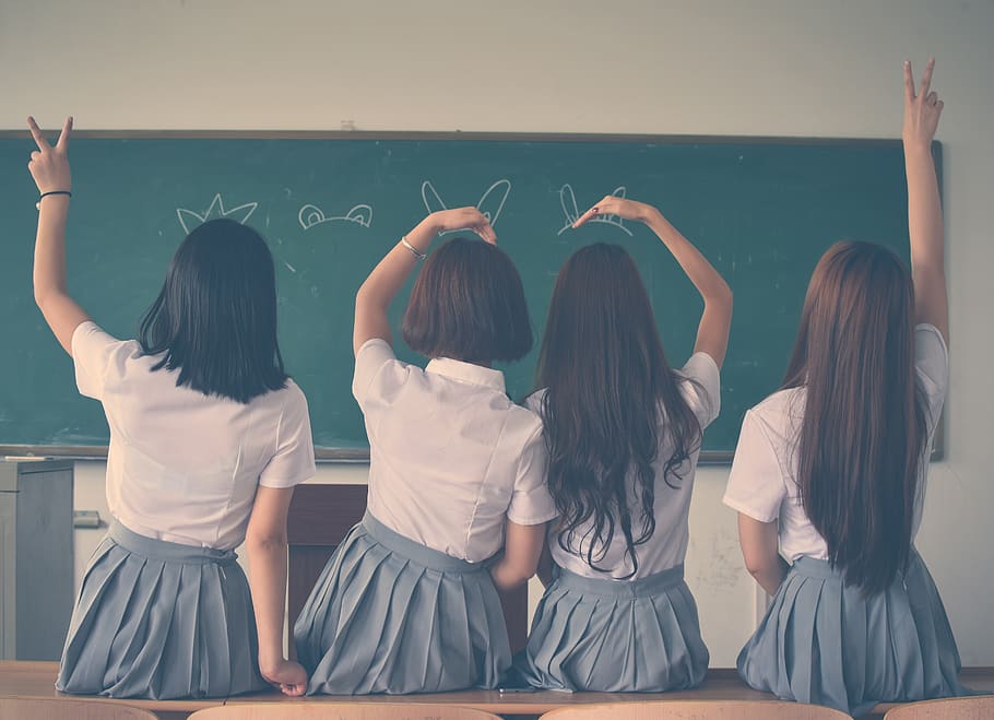 Photo of Four Girls Wearing School Uniform Doing Hand Signs, adolescent