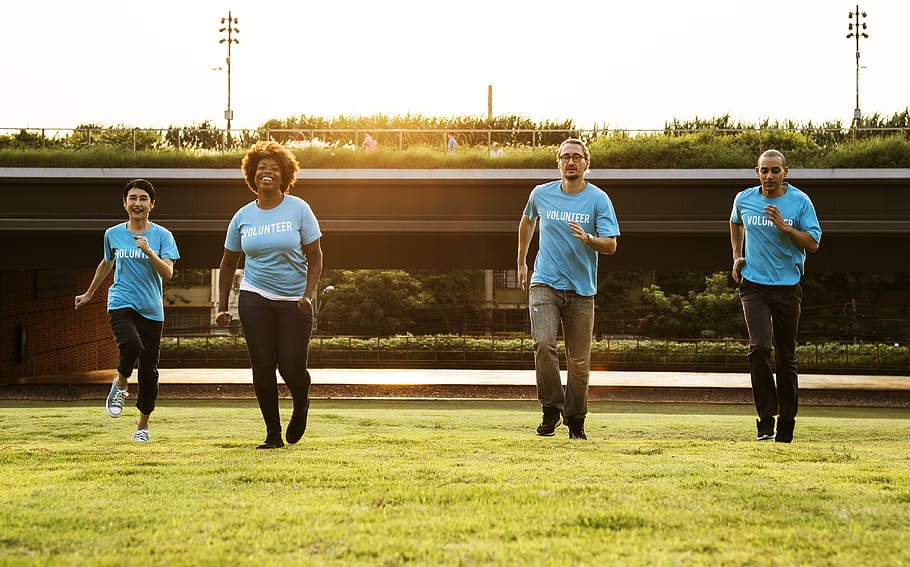 Four People Standing on Green Grass Field, active, adult, afro
