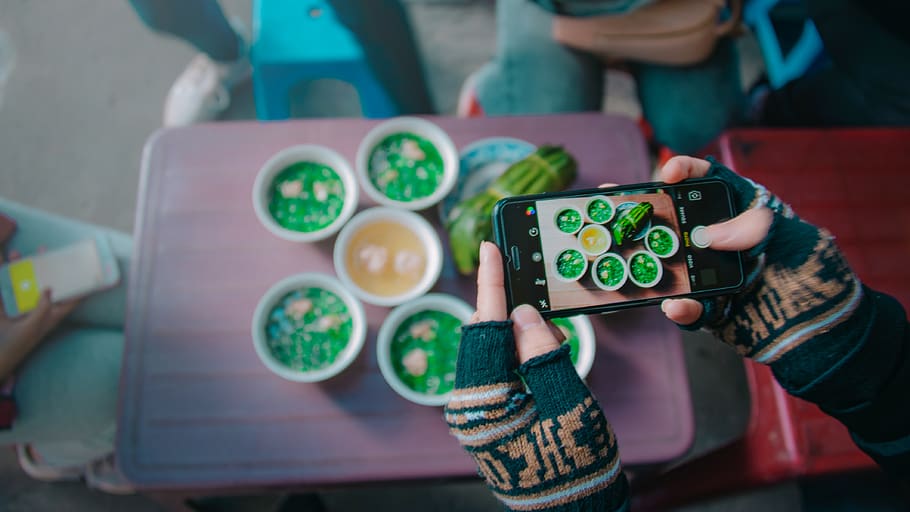 Person Holds Black Iphone Taking Photo of Round White Ceramic Bowl HD wallpaper
